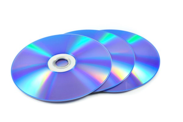 Three blank dvds on a white desk